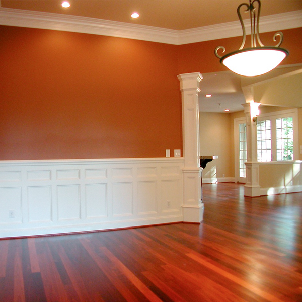 Picture of a room with wood floors and molding.