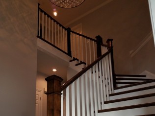 Galati Stairs Project Picture of a wooden staircase with iron railings in a house.